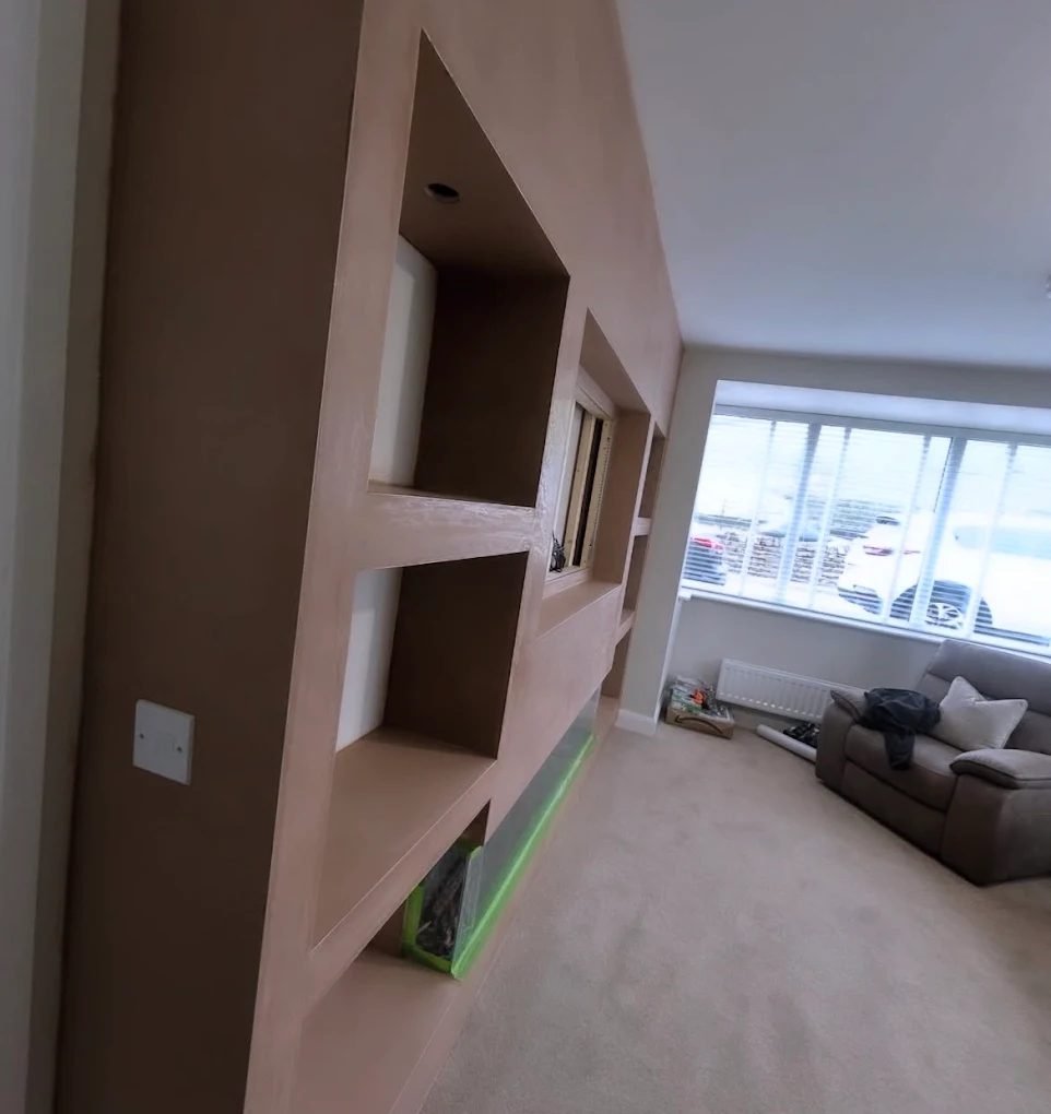 Feature wall with formed recesses freshly plastered in a living room