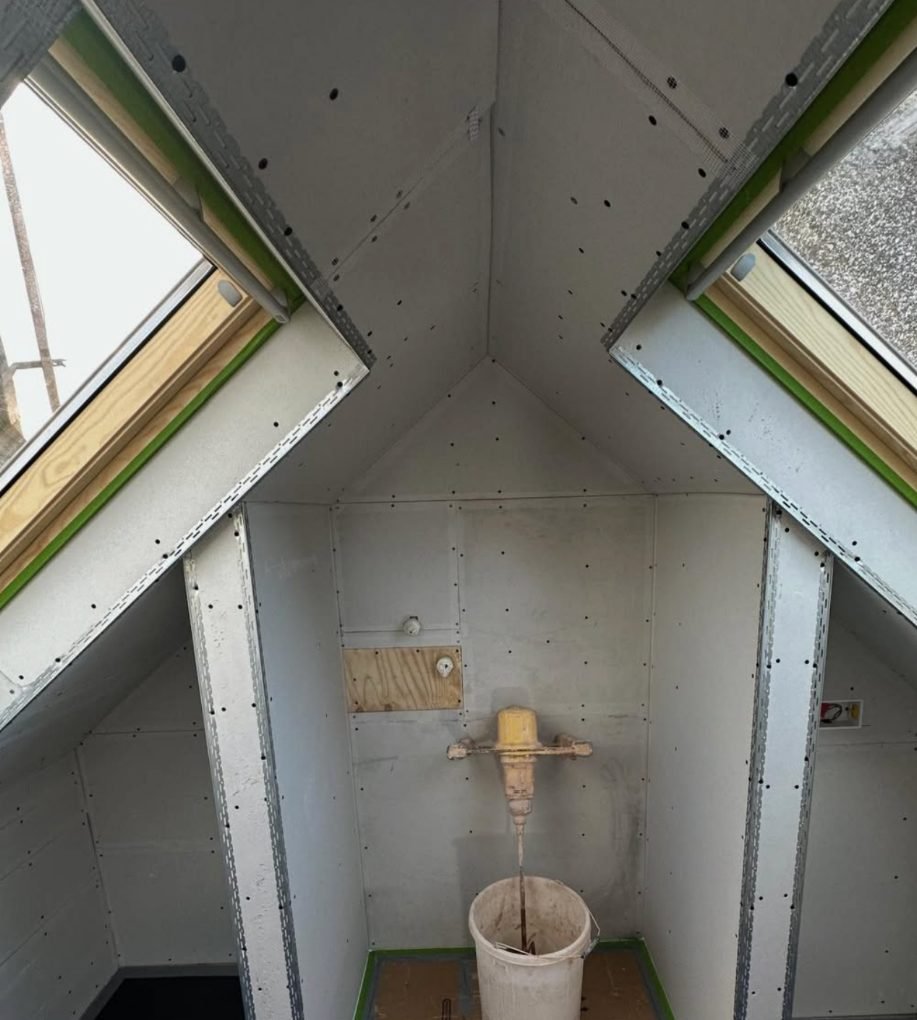 Loft conversion plasterboarded around two dormer windows